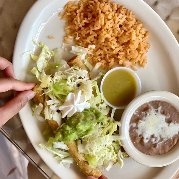 Habanero's Fresh Mex taquitos with rice, beans, guacamole, sour cream, and salsa verde.